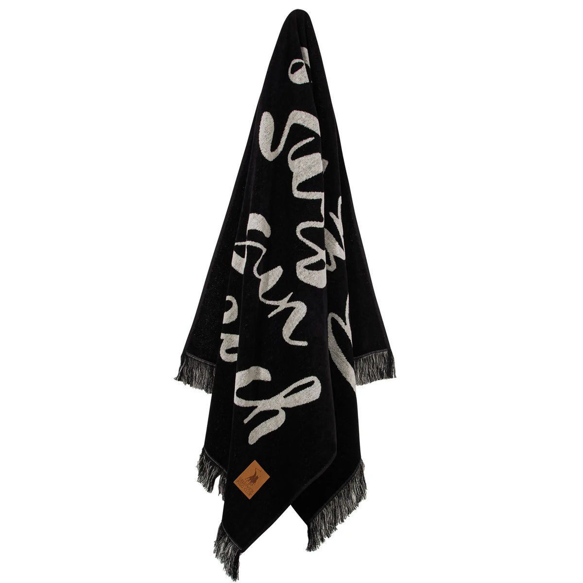 Hanging view of the Greenwich Polo Club cotton beach towel 3641 in black and sand with “Hello Summertime” lettering and fringed ends.