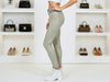 Side view of Griullo grey trousers with olive undertone, skinny fit and laminated leather-look finish.