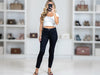 Full-length front view of black laminated slim-fit viscose-blend pants with a smooth leather-look finish.