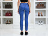Back view of marine-blue laminated slim-fit viscose-blend pants showing the rear pockets and slim-leg cut.