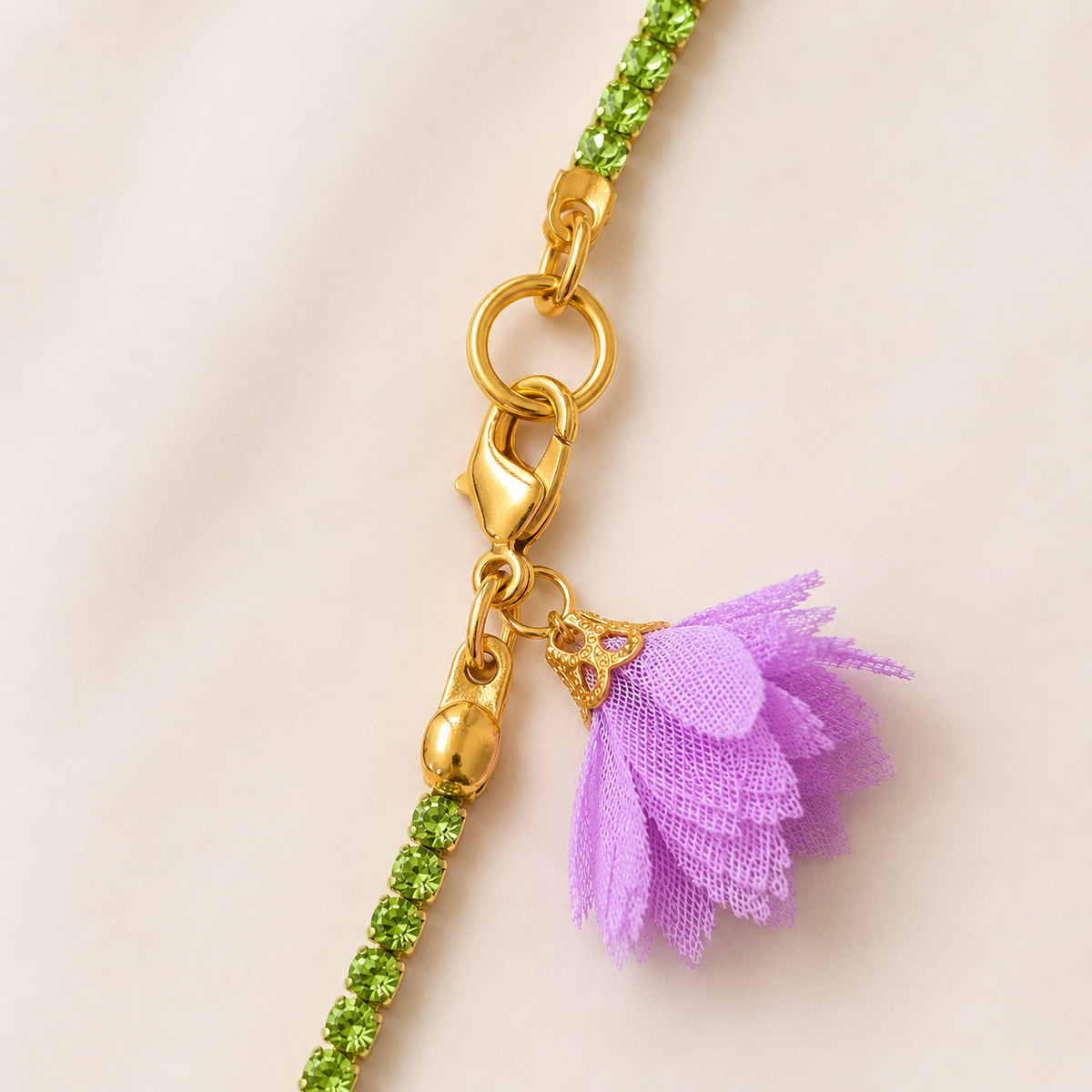 Close-up of green strass fashion necklace with purple textile flower and gold coloured closure at VVC SHOP Sitia Crete