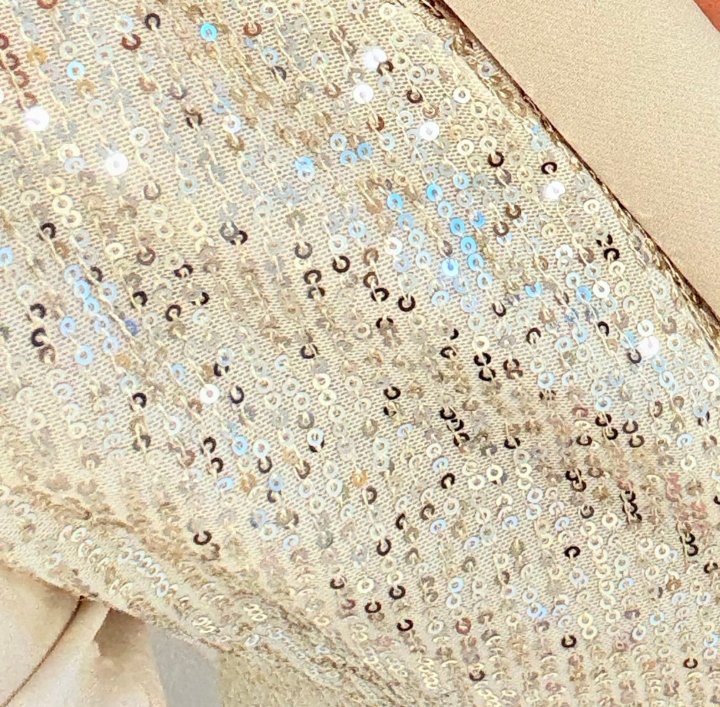 Close-up of a beige fabric with sequin embellishments