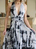 Close-up of batik fabric and integrated pleats on asymmetrical dress with deep V-neck