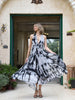 Asymmetrical pleated batik dress with deep V-neckline and A-line silhouette, front view
