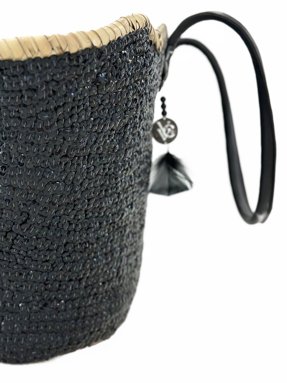 Side view of Handmade sequin basket with black shiny sequins and silver angel wings embroidery, featuring black leather handles. SHOPPING BAG, TOTE BAG, beach basket 