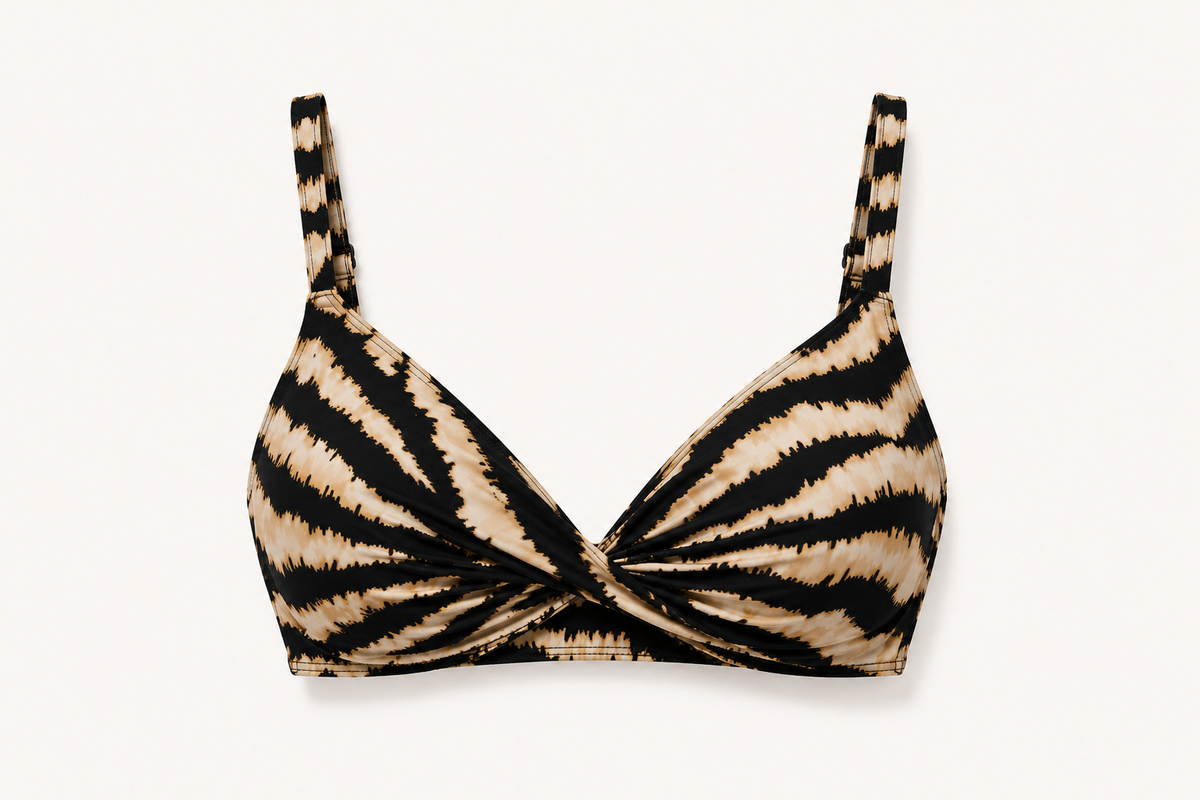Diver Luxury Swimwear zebra print bikini top with twist-front design, supportive C–D cup fit, adjustable straps and black back clasp, styled for luxury beach and resort wear.