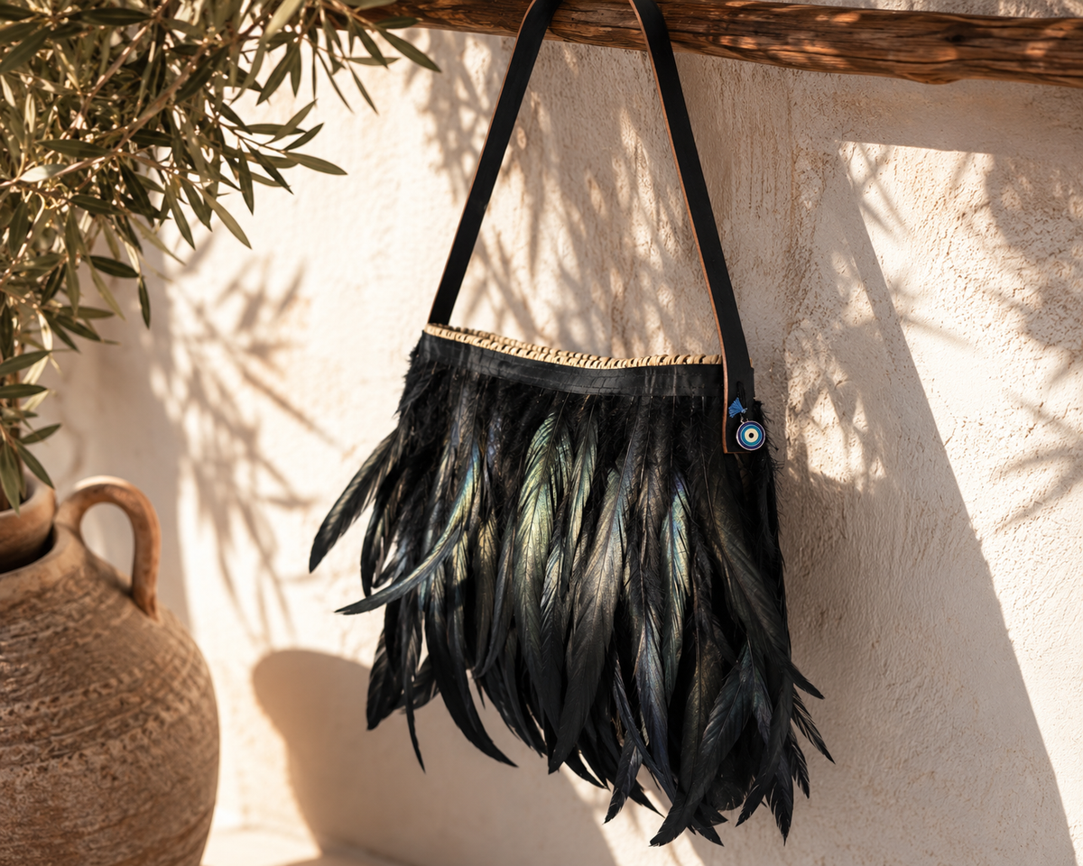 Front view of a VVC™ black feather shoulder bag made from natural raffia with elegant leather strap and handcrafted Greek design.