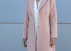 Close up front view and button closure of powder pink long coat handmade in Greece by VVC.