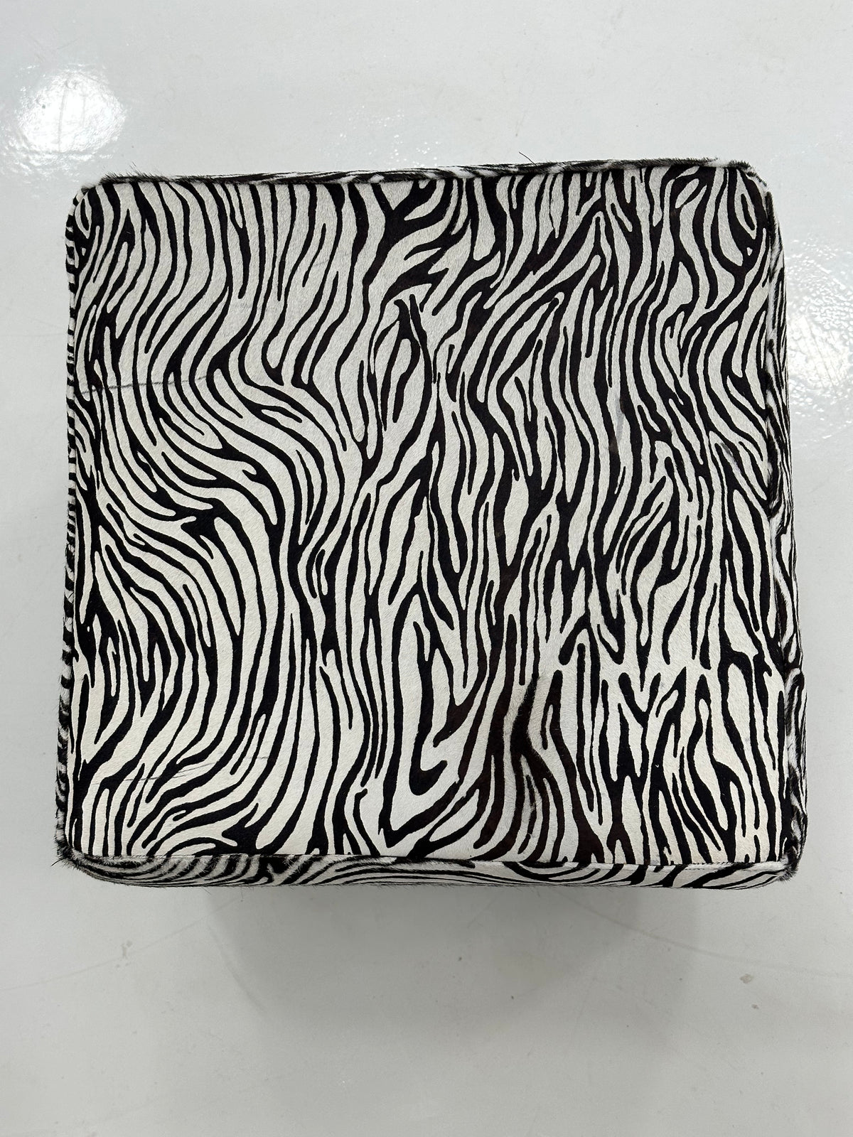 Above bird-eye view showing zebra cowhide seat surface and pattern on white background
