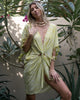 Woman in a green yellow boho short dress beach cover up shopping in Sitia, Crete