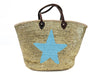 A handmade gold basket beach bag - shopping bag shoulder bag tote bad with a turquise sequin star decoration and a brown leather handle.
