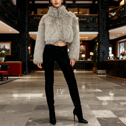 Person wearing a gray fluffy top and black pants in a stylish interior setting