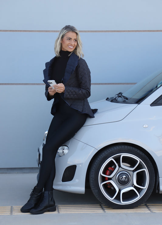 Side view of black and dark blue diamond quilt puffer jacket women’s jacket by VVC, featuring a fan-shaped collar and tailored fit, made in Greece.