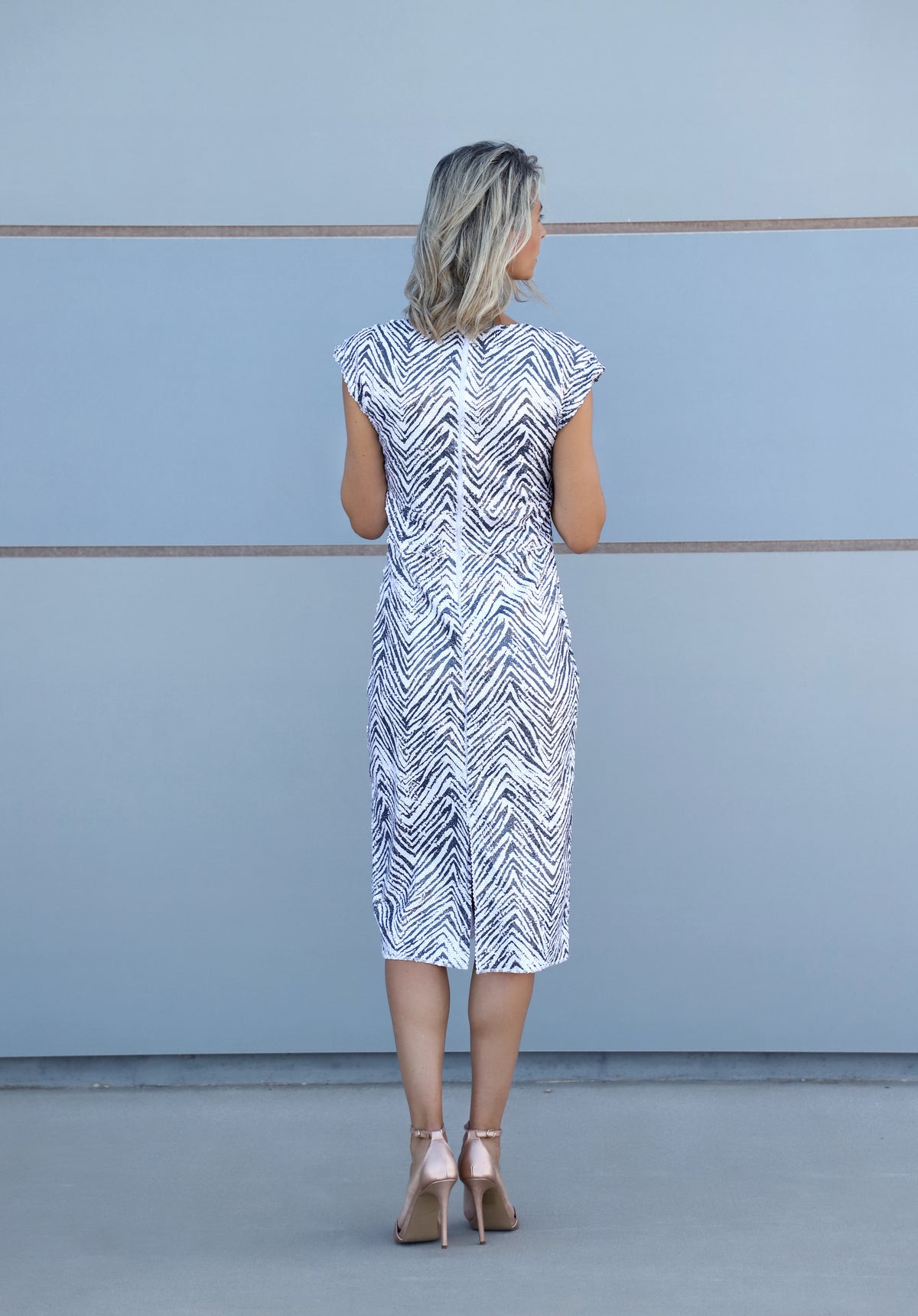 back view of VVC TM zebra sheath dress with matte sequins, exclusive at THE VVC SHOP SITIA Black Friday 2026.