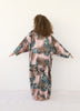 Back view of long pink animal print Italian silk kimono by VVC with tricolor cuffs, styled for an evening look.