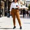 XXL Model wearing camel jeggings with white blouse, everyday chic.