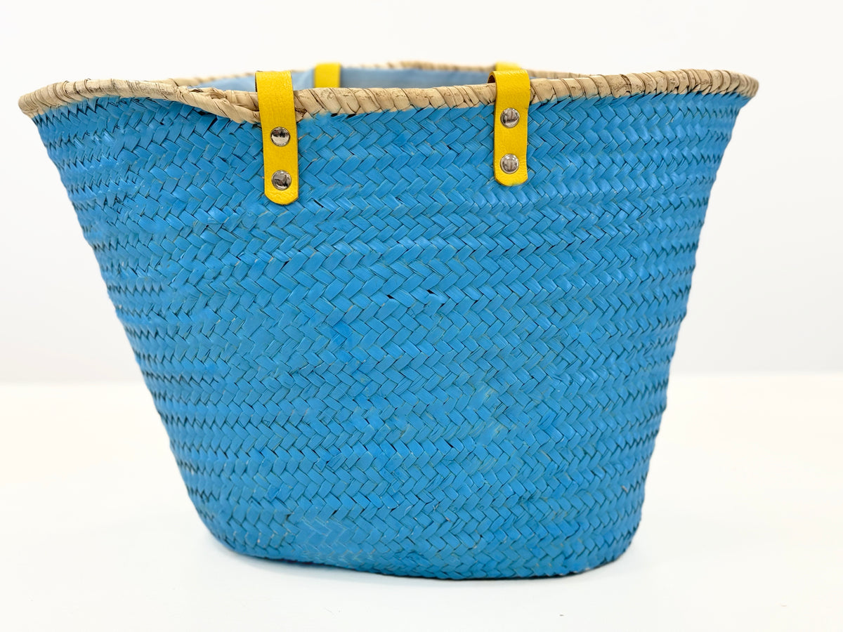 Back Side view of handmade turquoise palm leaf basket with yellow handles and sea star motif, designed for comfortable shoulder carrying.