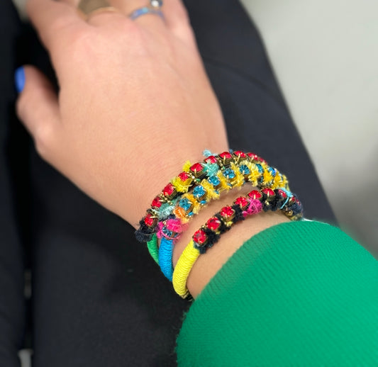 Close-up of a wrist wearing colourful ART WEAR Dimitriadis statement bracelets at VVC SHOP Sitia.