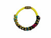 Side view of the ART WEAR Dimitriadis yellow leather and textile slim bracelet showing its circular shape and black details.