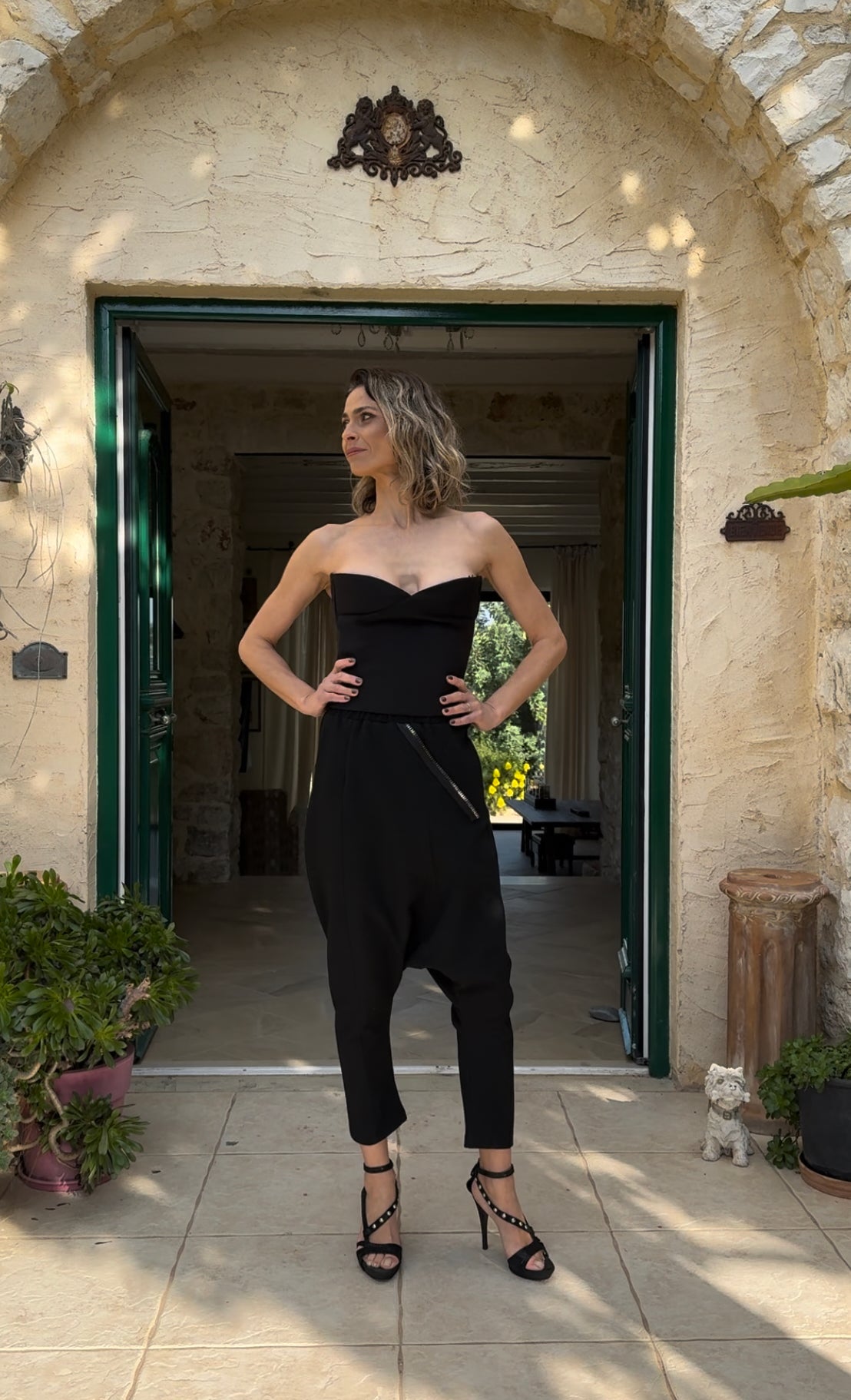 Woman wearing the Berrin black strapless bandeau bustier styled as a baptism guest outfit in Sitia, Crete.
