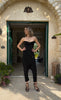 Woman wearing the Berrin black strapless bandeau bustier styled as a baptism guest outfit in Sitia, Crete.