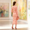 Back view of coral geometric long sleeve midi dress with straight fit and soft fabric drape, designed by BerrIn.