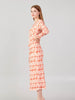 Profile view of coral long sleeve midi dress with geometric design and flattering straight silhouette by BerrIn.
