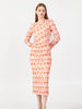 Elegant side angle of coral patterned midi dress showing gathered detail and lightweight fabric by BerrIn.