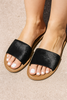 Black sandals worn on feet with a neutral background, vvc handmade black fur sandal summer essential crete sitia 
