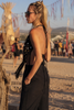 Side view of the black ZOE macramé halter top with long fringes and an open-back tie design