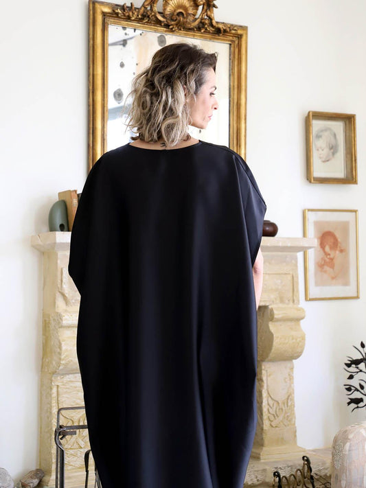 Full back view of a black oversized plus-size kaftan showing the loose silhouette, batwing sleeves and longer back hem