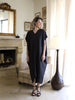 Full-length front view of a black plus-size kaftan with an airy oversized fit and asymmetric mullet hem at VVC SHOP Sitia, Crete