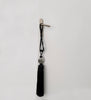 Black tassel quaste with a gray bead decorate old door