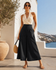 Caraclan black high-waist palazzo culotte pants in ultra-light summer fabric with slim waist, extra wide leg and modern 2026 resort style.