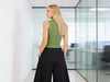 Cherry Blue Made in Italy warm green sleeveless knit top styled with wide black trousers for elegant minimalist fashion.