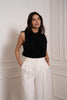 Black sequin turtleneck top by Choklate Paris styled with white trousers for modern evening outfits, parties and blazer layering in Sitia.