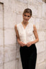 White sleeveless lace top by Choklate Paris styled with black trousers, perfect for office outfits, layering under blazers and elegant city looks.