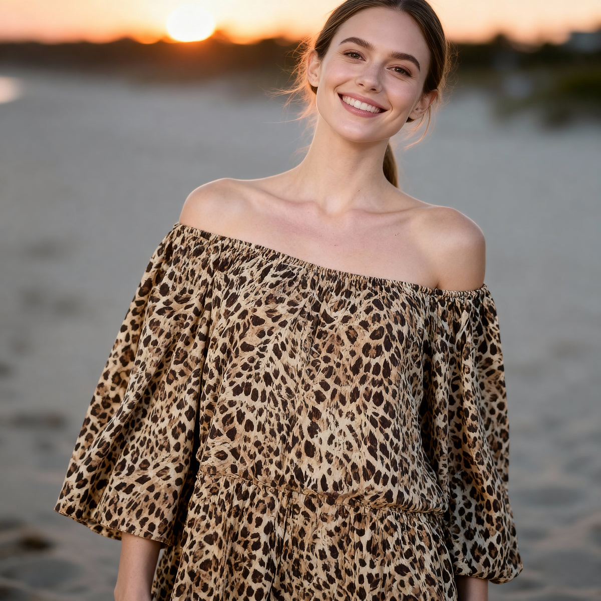 Model wearing the Civico camel-brown leopard off-shoulder maxi dress beside the coast in Sitia, Crete.
