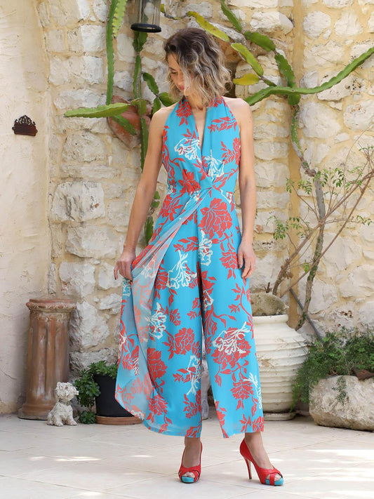 Side view of coral and turquoise silk-touch jumpsuit showing loose cut and flowy skirt-style design, VVC Shop exclusive.
