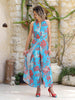 Side view of coral and turquoise silk-touch jumpsuit showing loose cut and flowy skirt-style design, VVC Shop exclusive.