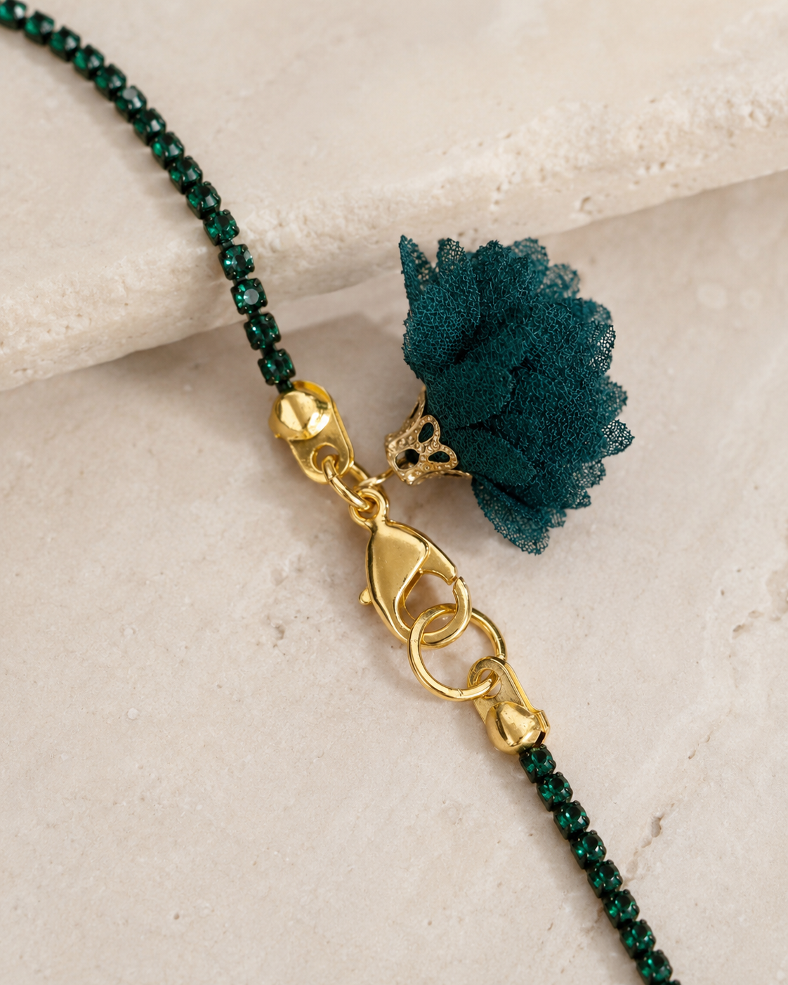 Detail view of dark green short necklace with gold clasp and tassel, available at VVC SHOP Sitia and online at viktoria-vigh.com in various colours.