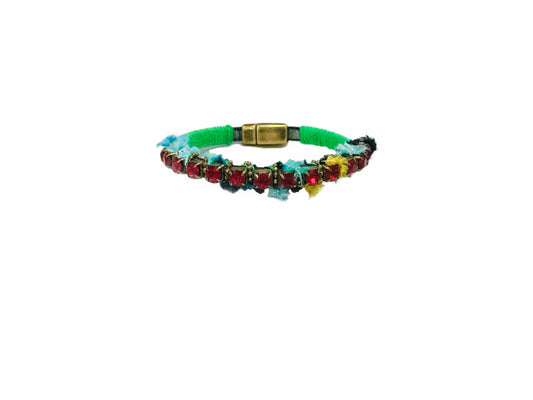 Side view of the Dimitriadis green circular bracelet with black and gold-tone details on a white background at VVC SHOP Sitia.