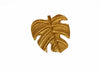 Front view of a gold Monstera leaf furniture knob with an 8 cm diameter.