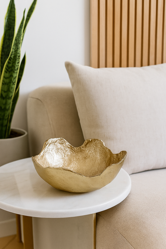 Handmade golden brass bowl used as a decorative centerpiece on a white side table, available at VVC SHOP Sitia Crete