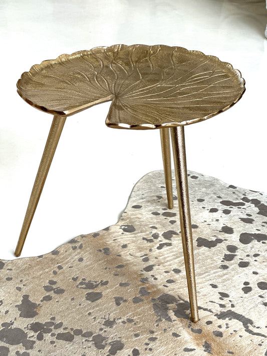 Side view of the Gold Lilly accent table — sculptural design with three legs, small and portable
5