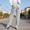Full-length back view of Gray Grullo carrot-cut trousers showing the relaxed tapered fit and ankle length at VVC SHOP Sitia, Crete.
