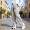 Side view of Made in Italy Gray Grullo carrot-cut trousers styled with white trainers at VVC SHOP Sitia, Crete.