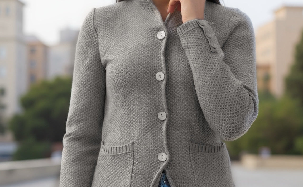 Front close up  view of the Sunny grey textured knit cardigan showing its fitted shape and pockets. .