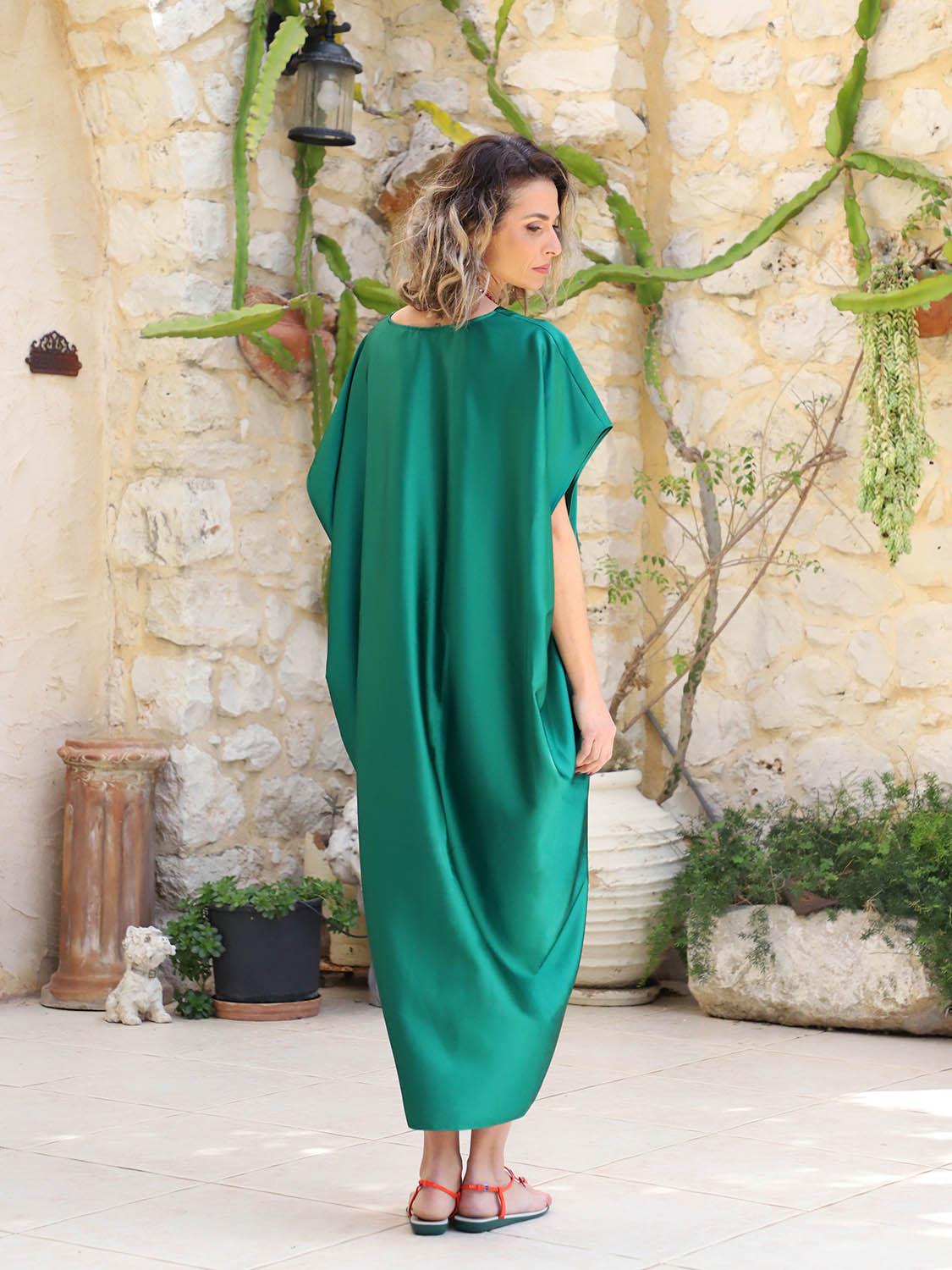 Side view of a green plus-size maxi kaftan showing the airy silhouette and longer mullet hem, available at VVC SHOP Sitia, Crete