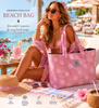 Greenwich Polo Club beach bag 50x38 cm in soft rose jacquard with large woven dots, carried by model at luxury beach club in Sitia Crete.